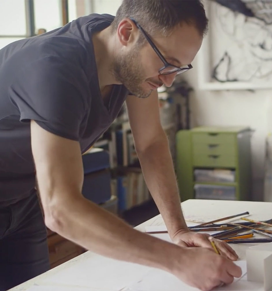 A man drawing with a pencil