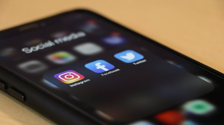 A phone with the top three social media platforms - Instagram, Facebook, and Twitter