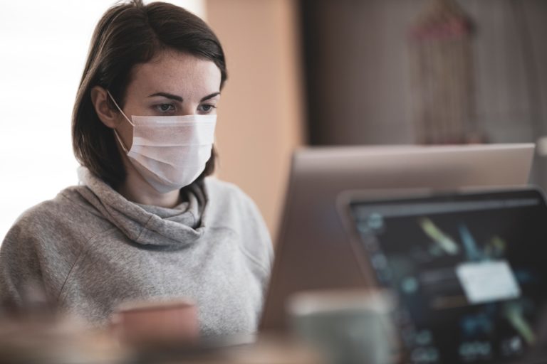An employee wearing a mask while in the office