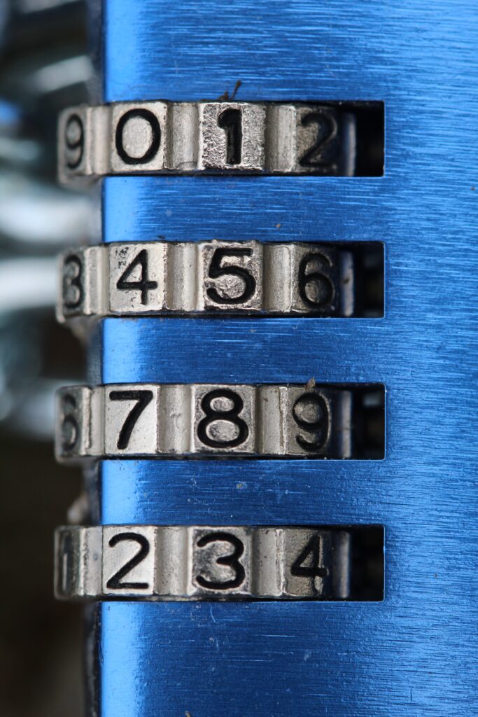 A blue combination lock with 4 dials, 9 digits on each dial